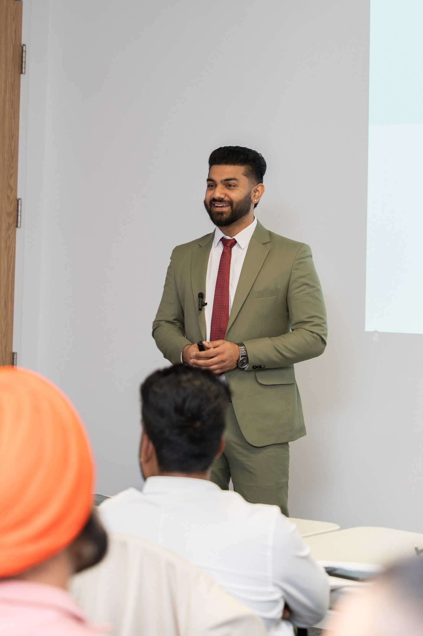 Dev Dhir explaining insurance options during a client presentation